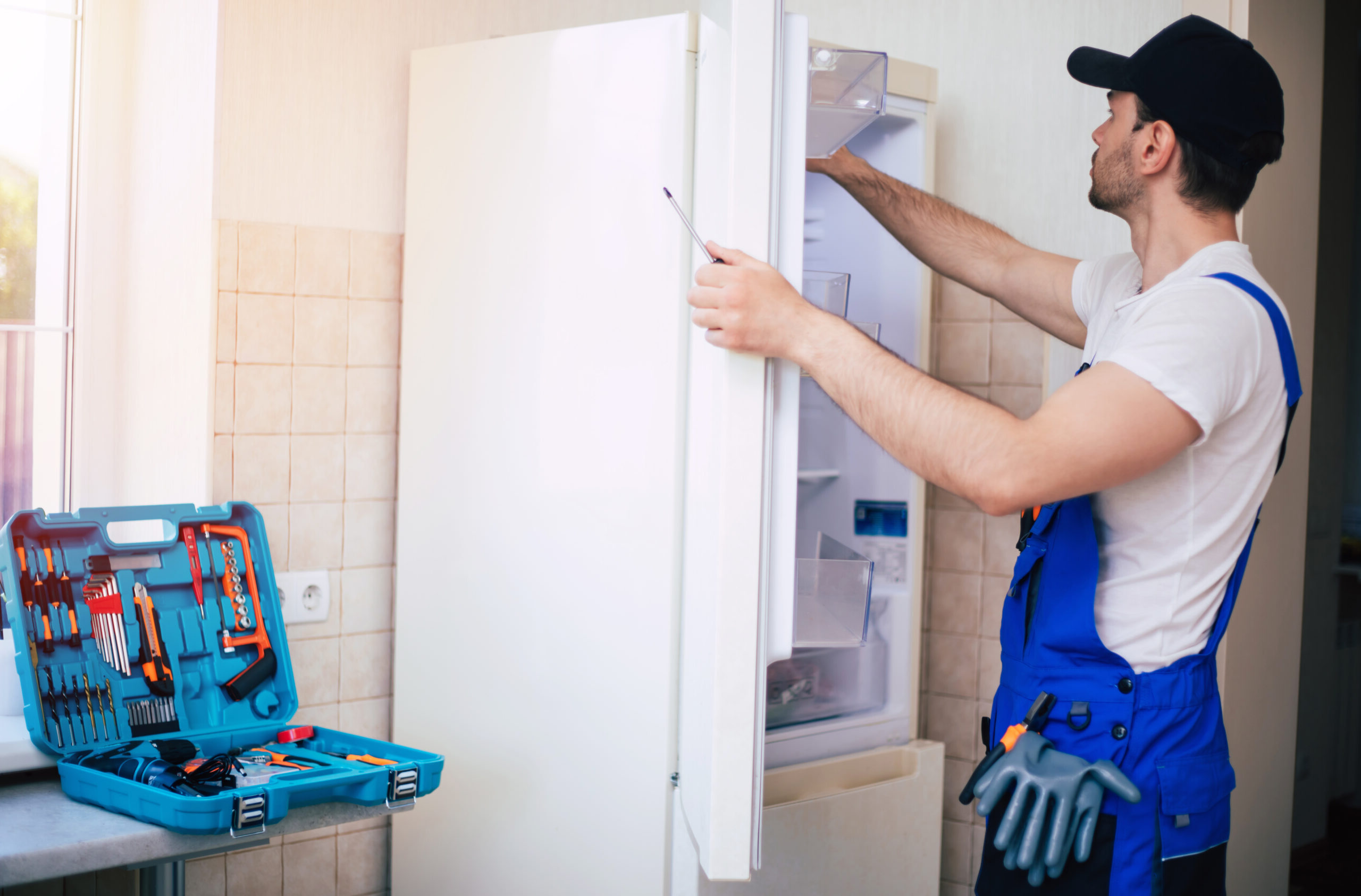 professional young repairman in worker uniform and cap with mode
